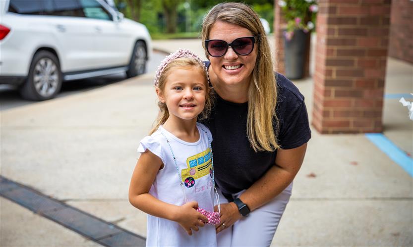 A mother and daughter smile